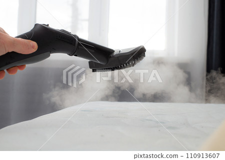 cleaning mattress with professional equipment in bedroom, closeup 110913607