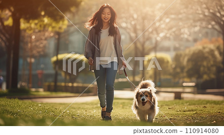 Asian woman walking a dog Asian woman walking a dog 110914080