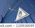 A fence with barbed wire and a triangle sign is extremely flammable. SDOF 110916699