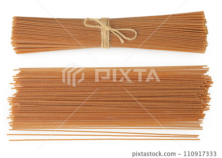 raw wholegrain spaghetti isolated on a white background. Top view. Flat lay 110917333