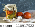 Fermented tomatoes on a dark wooden background with rough cloth. 110917522