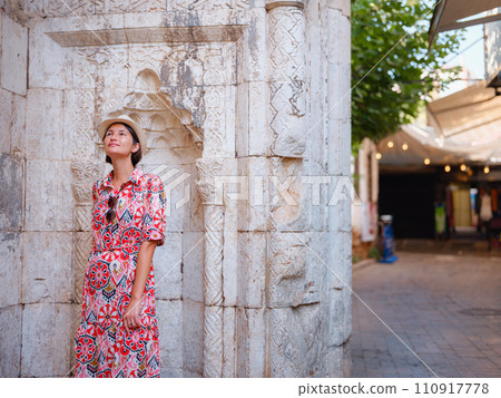 female summer travel to Antalya, Turkey. young asian woman in red dress walk through old town Kalechi , female tourist traveler discover interesting places and popular tourist attraction female summer travel to Antalya, Turkey. young asian woman in red dress walk through old town Kalechi , female tourist traveler discover interesting places and popular tourist attraction 110917778