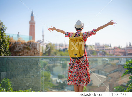 female summer travel to Antalya, Turkey. young asian woman in red dress walk through old town Kalechi , Panoramic view of Antalya Old Town , old otoman houses female summer travel to Antalya, Turkey. young asian woman in red dress walk through old town Kalechi , Panoramic view of Antalya Old Town , old otoman houses 110917781