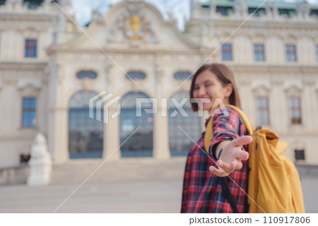 Female tourist traveling in Austria, capital city Vienna. summer female solo trip to Europe, happy young woman walking in park near Belvedere palace complex in Baroque style. Female tourist traveling in Austria, capital city Vienna. summer female solo trip to Europe, happy young woman walking in park near Belvedere palace complex in Baroque style. 110917806
