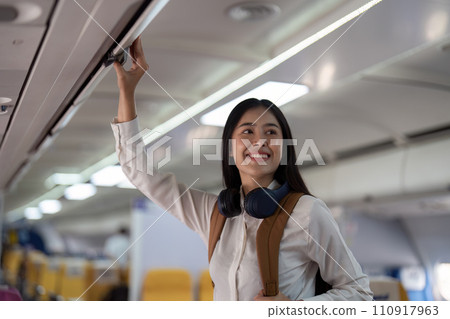 Alone Asian woman passenger traveling by plane. happy traveler on board. Solo travel concept Alone Asian woman passenger traveling by plane. happy traveler on board. Solo travel concept 110917963