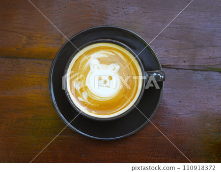 Top view of cappuccino With cute doll face cream on a wooden table 110918372