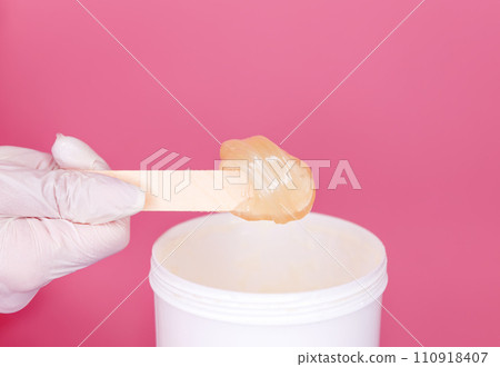 Hands cosmetologist holding paste for sugaring depilation. Depilation Hands cosmetologist holding paste for sugaring depilation. Depilation 110918407