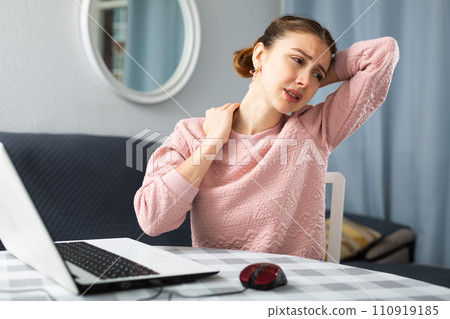 Young woman suffering from pain in neck 110919185
