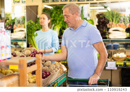 man buy large onion in supermarket man buy large onion in supermarket 110919243