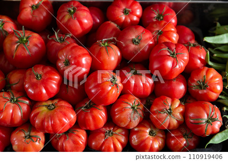 Harvest of ripe tomatoes, displayed for sale in the store 110919406