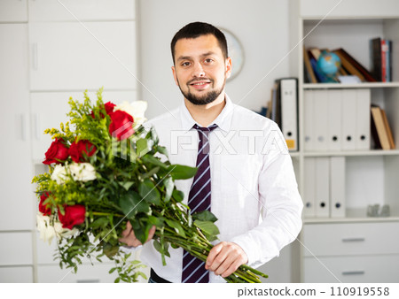 Portrait of cheerful office worker with bunch of flowers 110919558