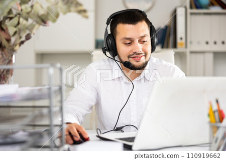 Portrait of positive man office worker wearing headset Portrait of positive man office worker wearing headset 110919662