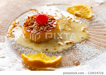 Tocino de cielo with caramel sauce, nuts and orange Tocino de cielo with caramel sauce, nuts and orange 110919728