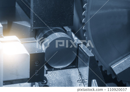 Close up scene the operation of circular blade saw cutting machine cutting the metal shaft parts with coolant method. Close up scene the operation of circular blade saw cutting machine cutting the metal shaft parts with coolant method. 110920037