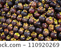 Heap of mangosteens, closeup of a fruit stall. Tropical fruit background 110920269