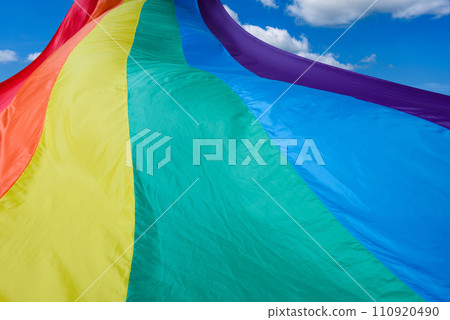 Fabric rainbow flag fluttering and going to sky. LGBT pride concept. pride month celebrates the festival background. Fabric rainbow flag fluttering and going to sky. LGBT pride concept. pride month celebrates the festival background. 110920490