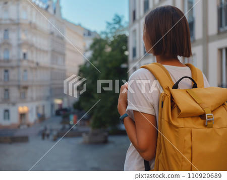 Female tourist traveling in Austria, capital city Vienna. summer female solo trip to Europe, happy young woman walking on european street. Female tourist traveling in Austria, capital city Vienna. summer female solo trip to Europe, happy young woman walking on european street. 110920689