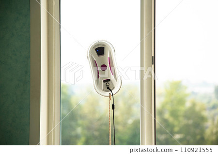 Vacuum automatic robot window cleaner cleans glass from dirt without human intervention and the risk of falling from a height. Window cleaning safety is top notch. Copy space for text 110921555