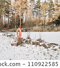 A life ring beside the winter frozen lake 110922585