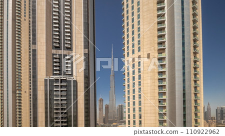 Tallest skyscrapers in downtown Dubai located on boulevard street near shopping mall aerial night to day timelapse. 110922962