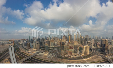 Panoramic skyline of Dubai with business bay and downtown district night to day timelapse. 110923004
