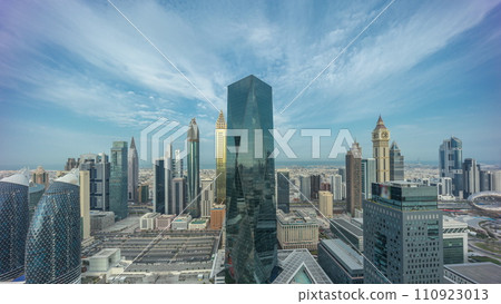 Panorama of futuristic skyscrapers in financial district business center in Dubai night to day timelapse 110923013