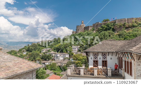 Panorama showing Gjirokastra city from the viewpoint with the fortress of the Ottoman castle of Gjirokaster timelapse. Panorama showing Gjirokastra city from the viewpoint with the fortress of the Ottoman castle of Gjirokaster timelapse. 110923067