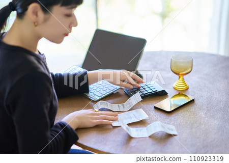 young woman holding a receipt young woman holding a receipt 110923319