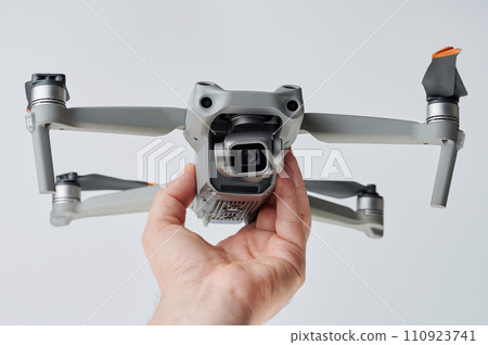 Gray drone with camera in hand 110923741