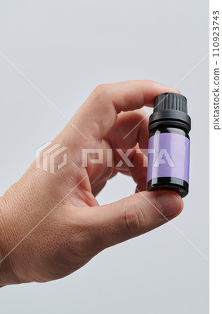 Hand hold small glass bottle Hand hold small glass bottle 110923743