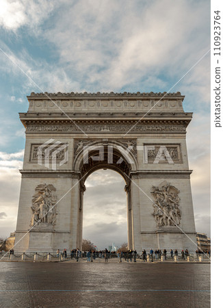 Famous Arc de Triomphe (Triumphal Arch) at the city center of Paris and traffic trails in Chaps Elysees. Famous Arc de Triomphe (Triumphal Arch) at the city center of Paris and traffic trails in Chaps Elysees. 110923764
