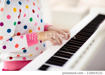 Child playing piano. Kids play music. Child playing piano. Kids play music. 110924132