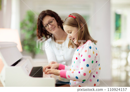 Child playing piano. Kids play music. 110924157