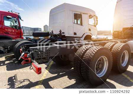 Back view many new heavy commercial cargo transport vehicles stand at port for export import shipping in Germany. Modern semi-trailer business industry truck tractor chassis sale sea logistics Back view many new heavy commercial cargo transport vehicles stand at port for export import shipping in Germany. Modern semi-trailer business industry truck tractor chassis sale sea logistics 110924292