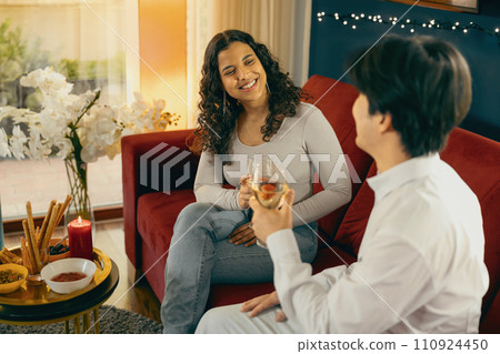 Happy young friends drinking wine and enjoying time together at festive dinner party at home Happy young friends drinking wine and enjoying time together at festive dinner party at home 110924450
