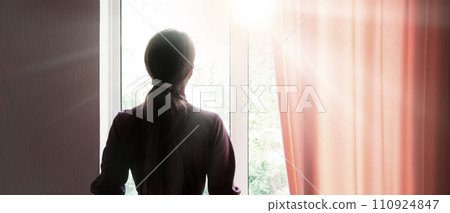 Praying woman at the window 110924847