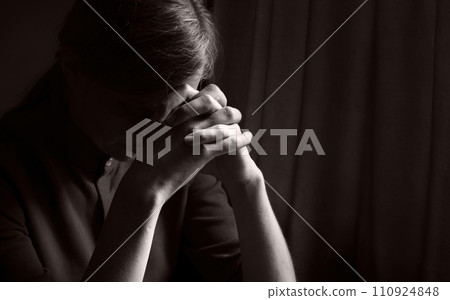 Praying woman at the window 110924848