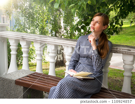 Girl writes in a notebook Girl writes in a notebook 110924857