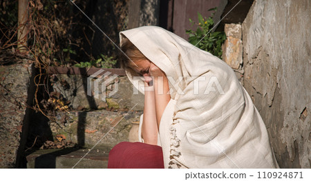 Sad girl sitting on the ground 110924871