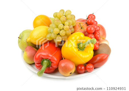 Fruits and vegetables on a plate isolated on white. 110924931