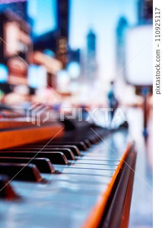 Brochure design for cultural events featuring piano performances. Close-up of piano with blurred people on background 110925117
