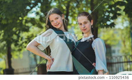 Portrait of two Russian schoolgirls graduating from high school. 110925436