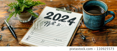 On a chair block of 2024 and a cup of caffeine 110925573