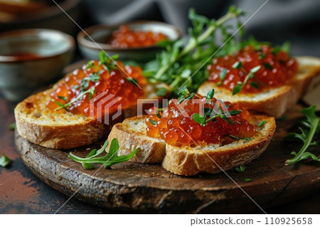 Sandwich with red caviar on a wooden table: a treat for connoisseurs of taste 110925658