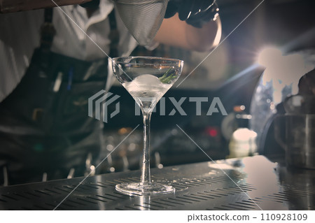 Close-up view of a cocktail glass on the bar counter. Close-up view of a cocktail glass on the bar counter. 110928109