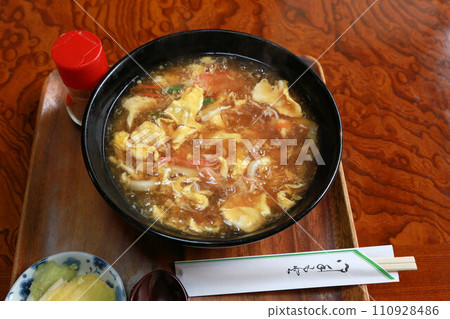 來自日本餐廳的美味厚實的雞蛋和蟹棒烏龍麵。 來自日本餐廳的美味厚實的雞蛋和蟹棒烏龍麵。 110928486