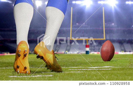 American football player kicking ball in close up. American football player kicking ball in close up. 110928958