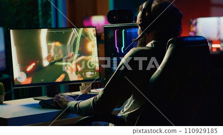 Player reaching final mission in coop FPS videogame, battling flying robots with his online friends. Gamer playing first person shooter game, fighting final boss helped by internet teammates 110929185