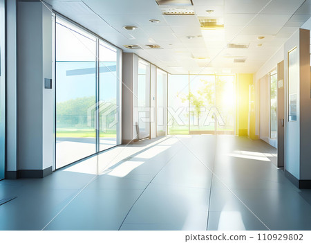 Light blurred background. The hall of an office or medical institution with panoramic windows and a perspective. Light blurred background. The hall of an office or medical institution with panoramic windows and a perspective. 110929802