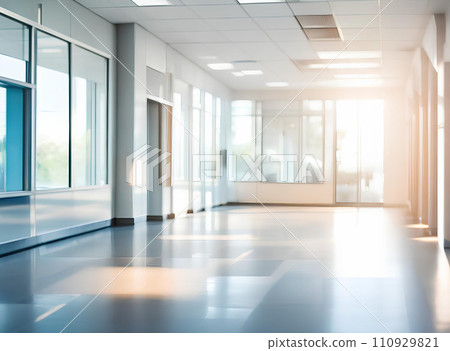 Light blurred background. The hall of an office or medical institution with panoramic windows and a perspective. Light blurred background. The hall of an office or medical institution with panoramic windows and a perspective. 110929821